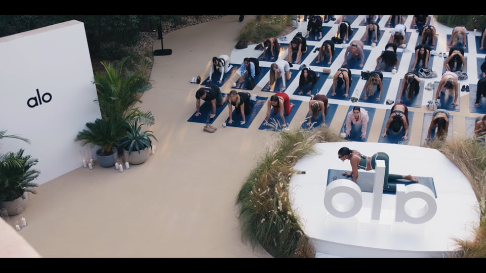 Group yoga session filmed during an ALO brand activation in Dubai.