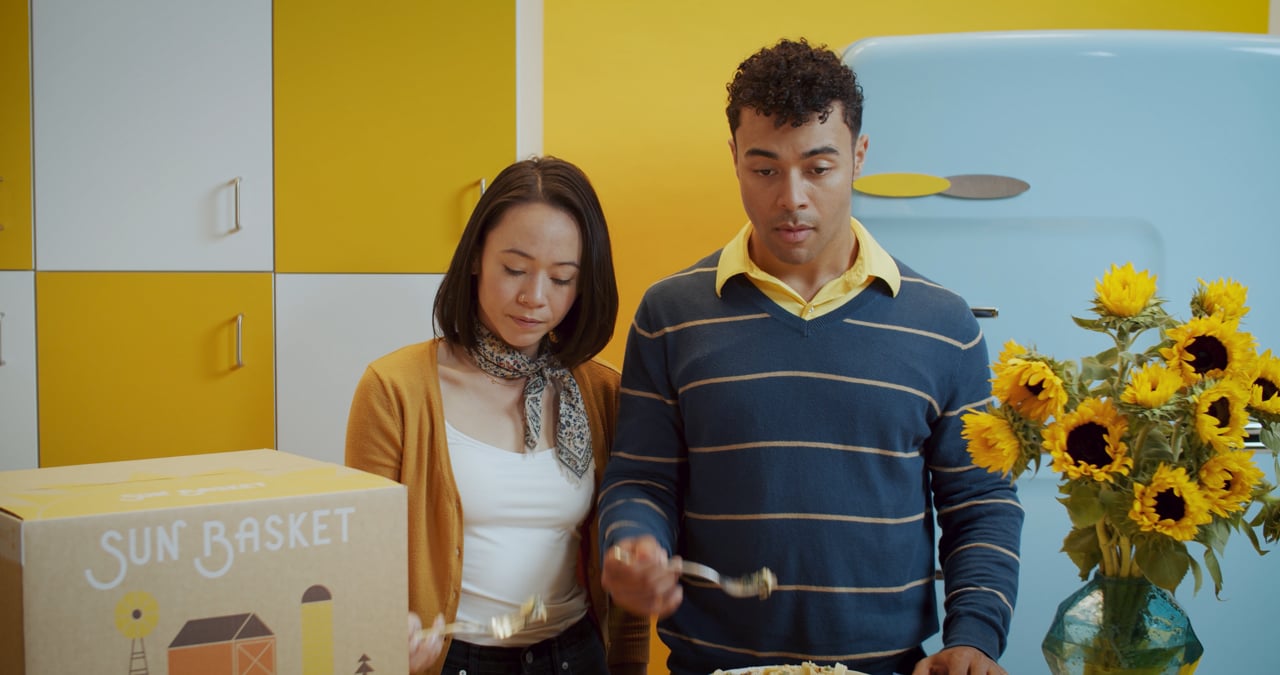 A frame from the finished spot: the party state, tubes lit, the kitchen gone