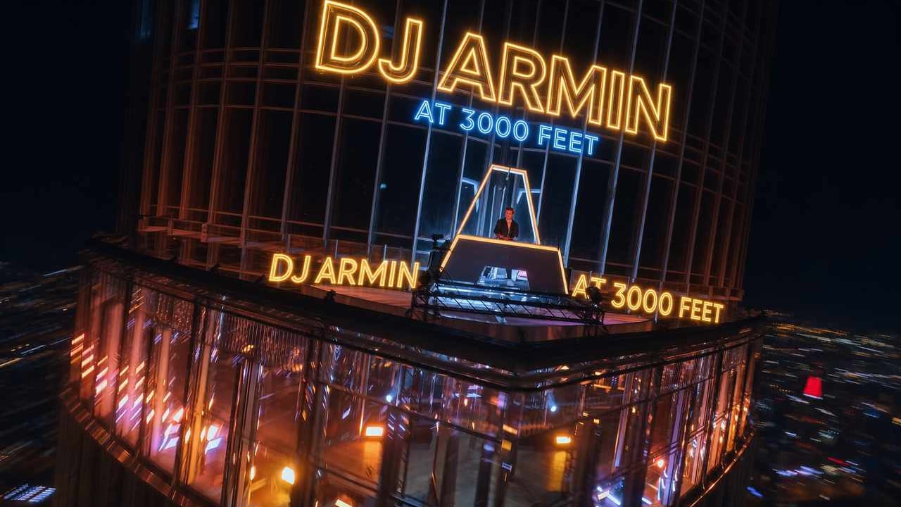 Armin van Buuren performing on top of the Burj Khalifa at night, filmed by ChopperShoot drones