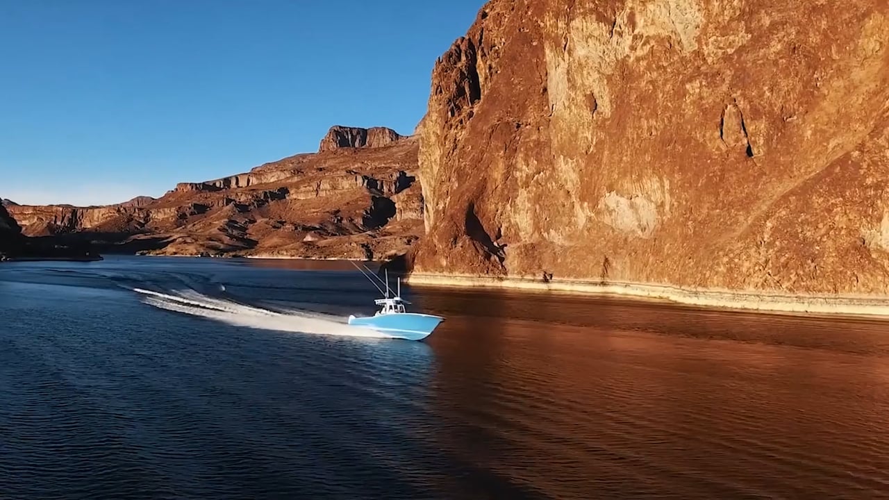 Center console boat running through a desert canyon lake, aerial cinematography by Hilo Motion Pictures