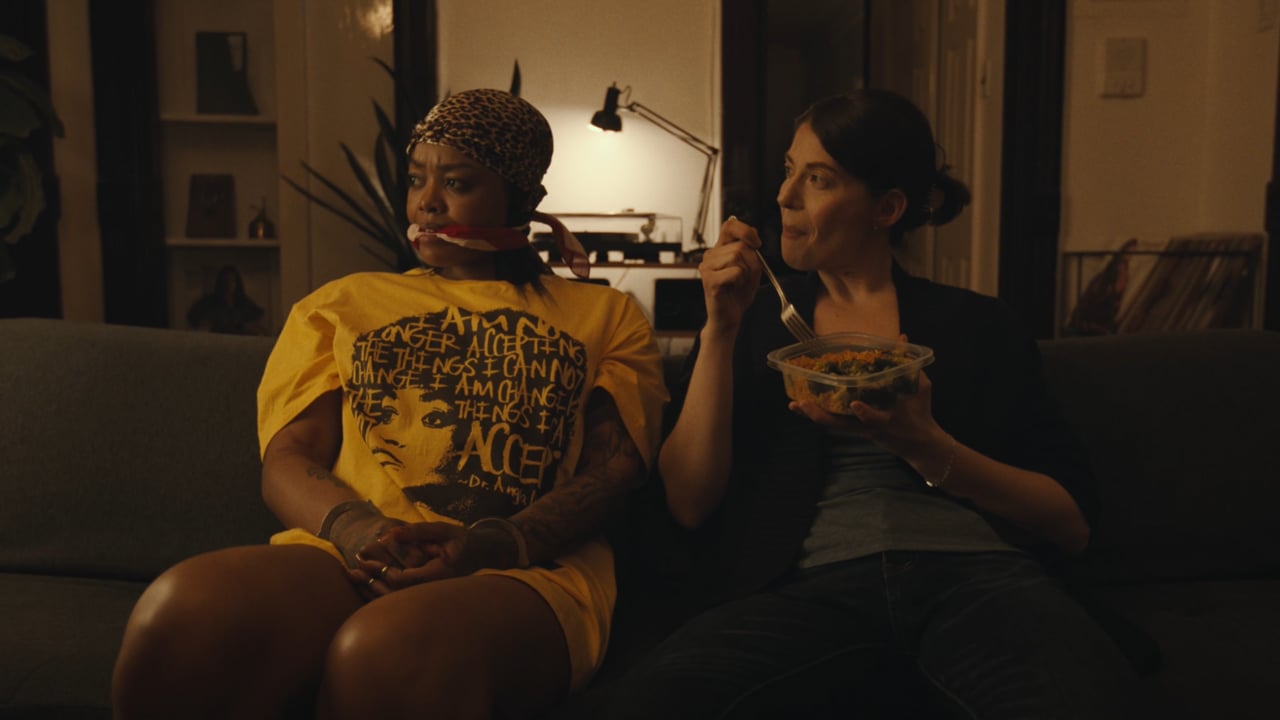 Two women sitting together on a couch in You Ain’t Gotta Go Home.