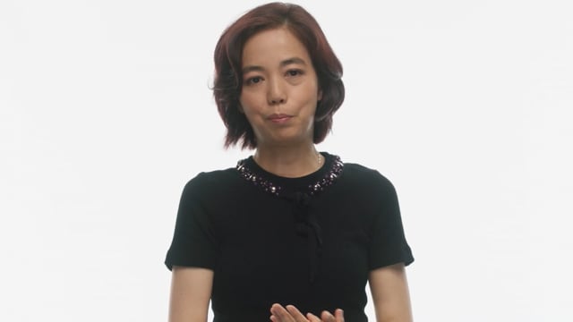 A speaker in Google: Advancing AI for Everyone, against the film’s white studio background.