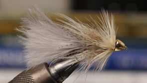 A fly vise holding a undefined after it is tied