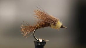 A fly vise holding a undefined after it is tied