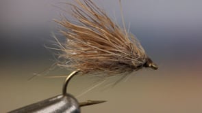 A fly vise holding a undefined after it is tied