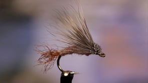 A fly vise holding a undefined after it is tied
