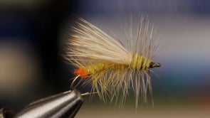 A fly vise holding a undefined after it is tied