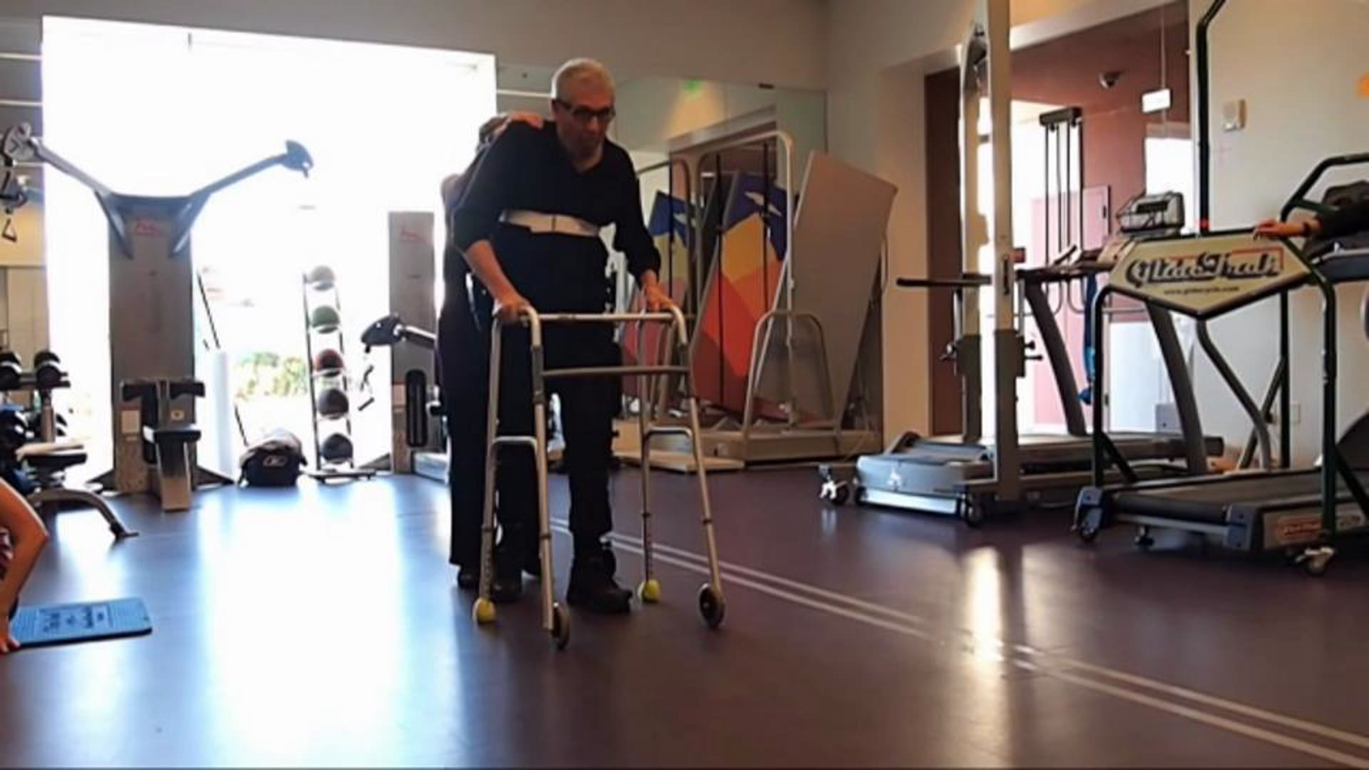Kickstart helps user with spinal cord injury walk during physical therapy