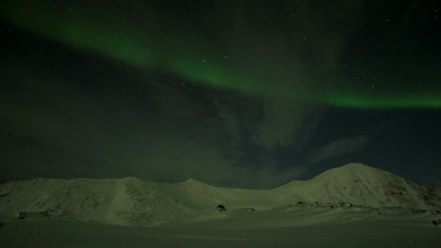 Aurora Borealis Over Snowy Mountains