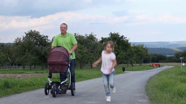 Father Pushing Baby Stroller