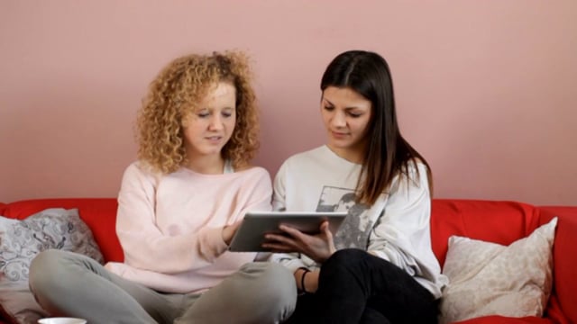Young Women Use a Tablet Computer