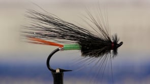 A fly vise holding a undefined after it is tied