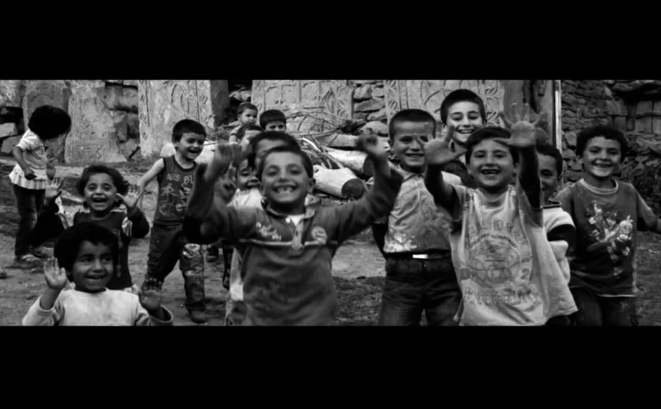 Armenian children cheering in outdoor square