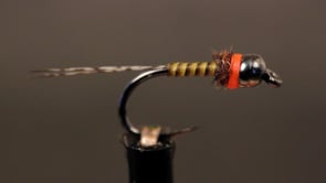 A fly vise holding a undefined after it is tied