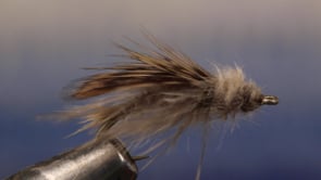 A fly vise holding a undefined after it is tied