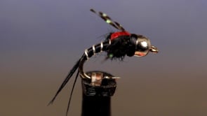 A fly vise holding a undefined after it is tied