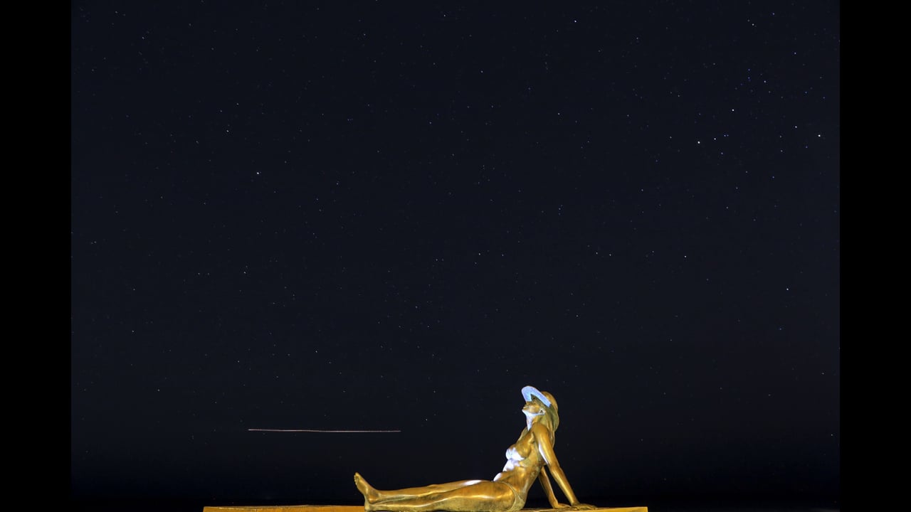Gold Coast Currumbin Star Timelapse moving across the night, above the famous bronze lady