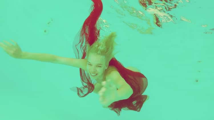 Beautiful blonde sunning naked on a pool's diving board