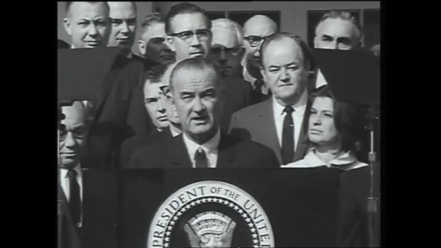 film footage of President Johnson signing NEH legislation