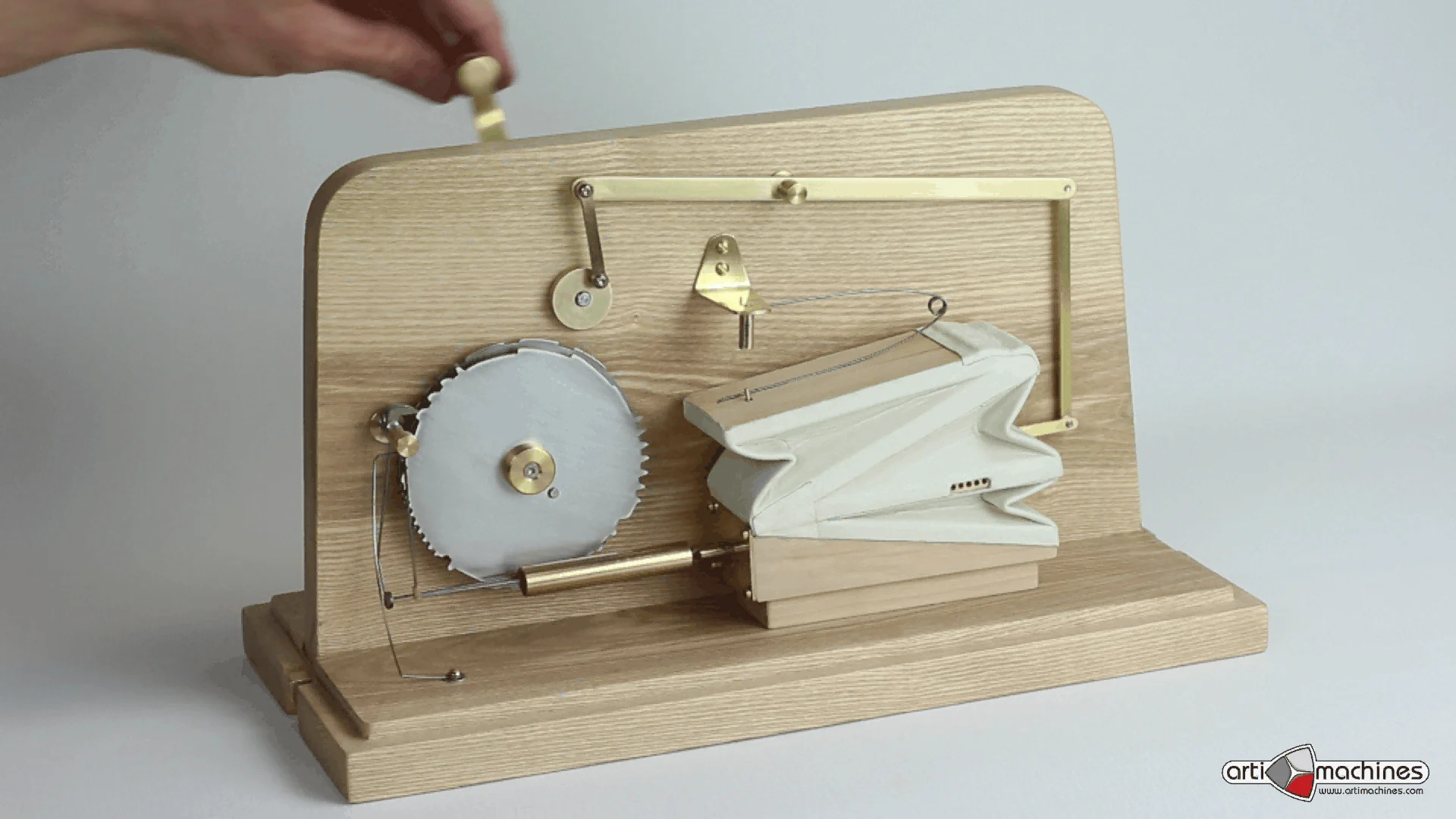 A wooden mechanical singing-bird model showing its crank and internal mechanism; this is not Molly from Art of Play