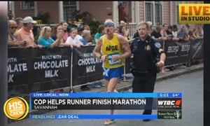 Officer HElps Marathoner Cross Finish Line