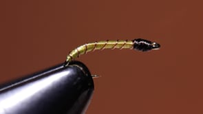 A fly vise holding a undefined after it is tied