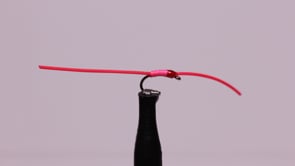A fly vise holding a undefined after it is tied