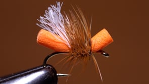 A fly vise holding a undefined after it is tied