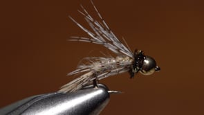 A fly vise holding a undefined after it is tied