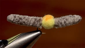 A fly vise holding a undefined after it is tied