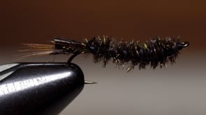 A fly vise holding a undefined after it is tied