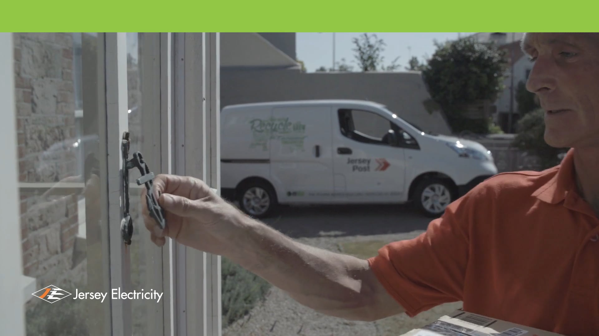 Postman knocks on door with an electric van in background