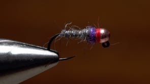 A fly vise holding a undefined after it is tied