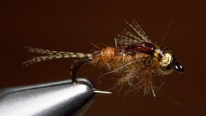 A fly vise holding a undefined after it is tied