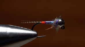 A fly vise holding a undefined after it is tied