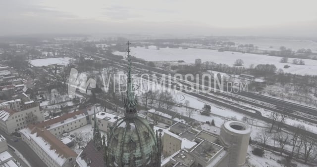 Drone Circling Church Spire on Foggy Snowy Day