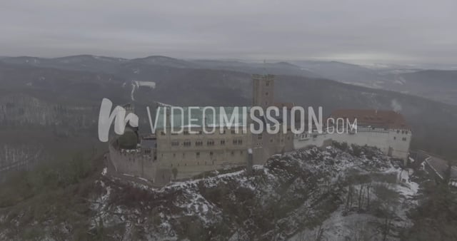 Drone Flying Away From European Castle In Winter