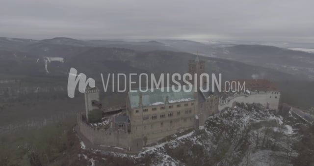 Drone Flying High Above Castle On A Foggy Day