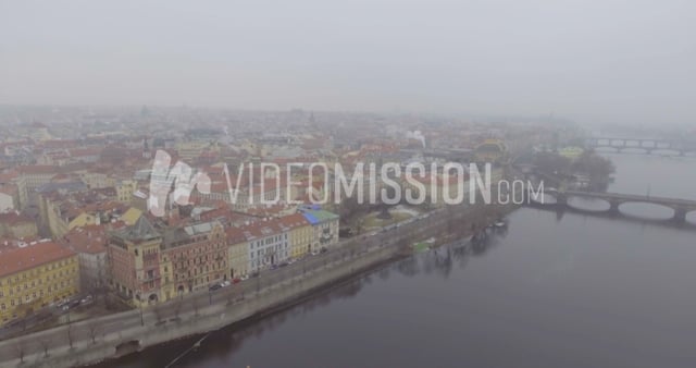 Drone Flying Over River Toward City In Winter