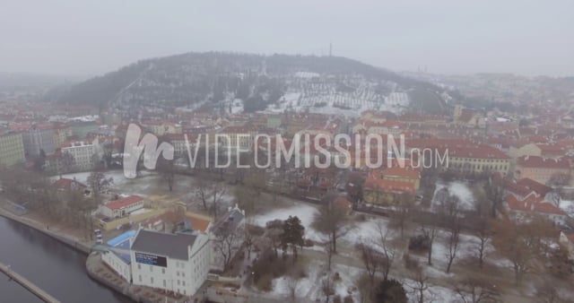 Drone Flying Over River Toward European City