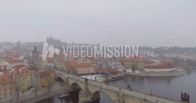 Drone Flying Over River Towards Bridge On Foggy Day