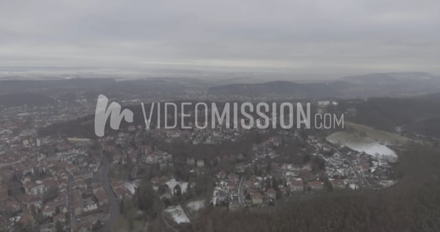 Drone Flying Over Snowy European City In Fog