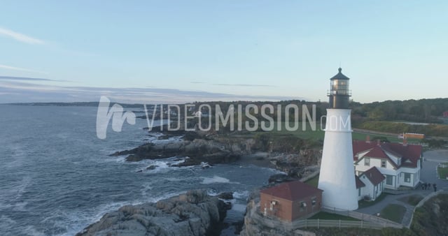 Drone Flying Over Ocean Toward Lighthouse