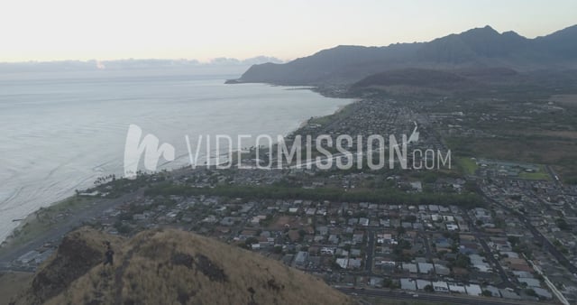 Drone Flying Past Man Of Ridge Toward Ocean