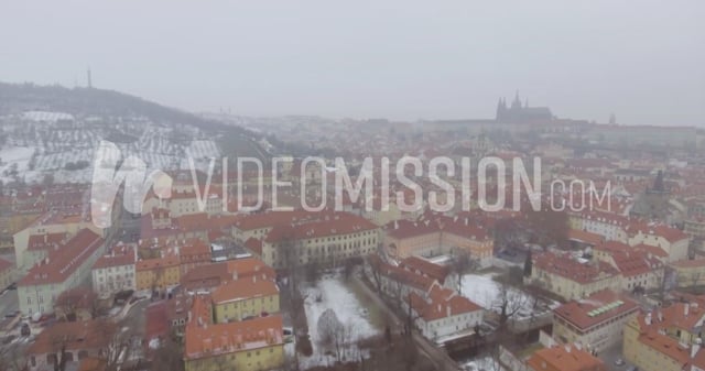 Drone Flying Toward Snowy European City In The Fog