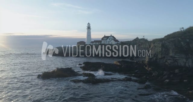 Drone Rising From Ocean Above Lighthouse