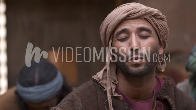 Close Up Slider Shot Of Man Praying In A Group