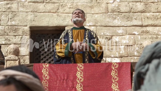 King Prays Toward Heaven Above Crowd Close Up