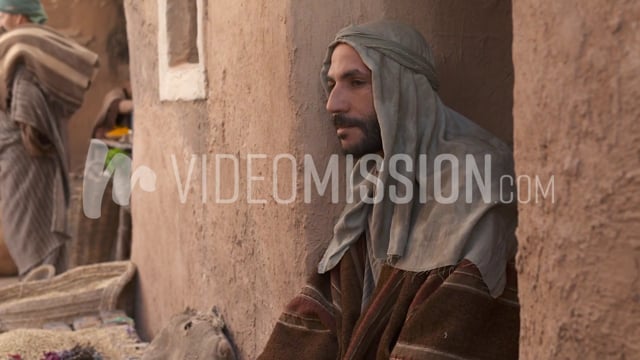 Man Looking Around Near Wall