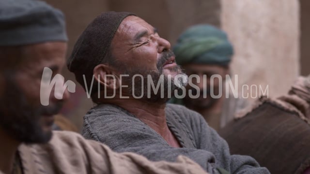 Man Praying In A Group Of Men